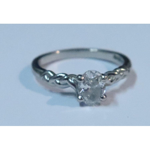 438 - A platinum single stone diamond ring, claw set oval-cut diamond of approximately 0.60ct within rope ... 