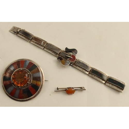 440 - A Scottish silver circular brooch, set with an orange citrine to the centre, surround by panels of a... 