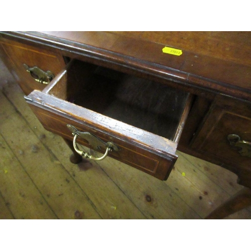 46 - An 18th century walnut low boy, quarter veneer with cross banded top, fitted three drawers to frieze... 