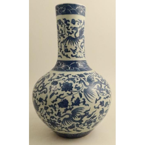 471 - A Chinese blue and white bottle vase, decorated with a phoenix and flowers tendrils, Qianlong seal m... 