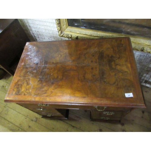 48 - An 18th century walnut kneehole desk, having a quarter veneer cross banded top, fitted one long draw... 