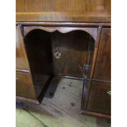 48 - An 18th century walnut kneehole desk, having a quarter veneer cross banded top, fitted one long draw... 