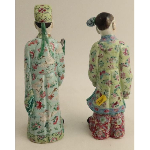 487 - A pair of late 19th century/early 20th century Chinese porcelain figures, modelled as dignitaries in... 