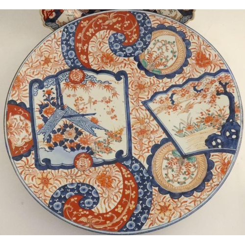 500 - A large circular Imari charger, diameter 22ins, together with a square Imari charger, with rebated c... 