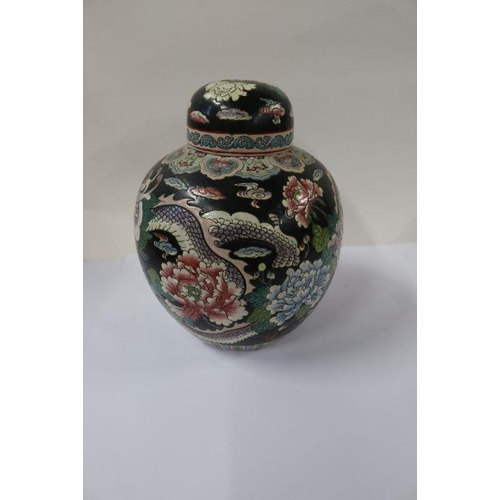 501 - A pair of Oriental covered ginger jars, decorated with dragons and flowers to a black ground, height... 