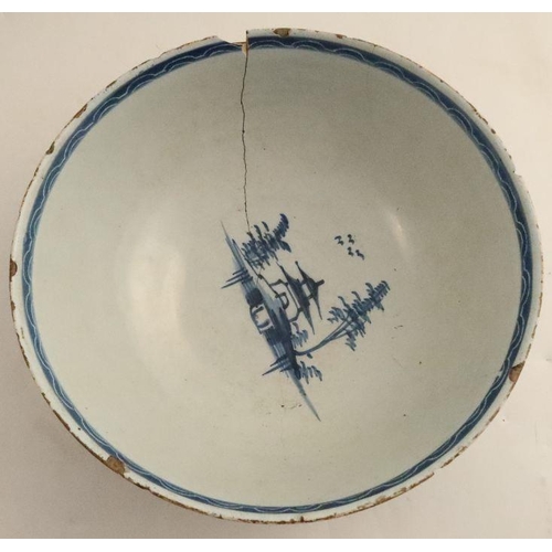 507 - Two blue and white Delft bowls, decorated with landscapes and foliage