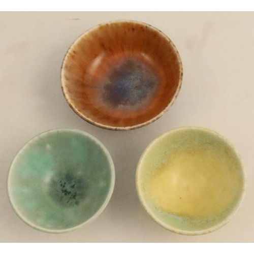 517 - Three Ruskin pottery bowls, decorated with matt crystalline glazes, diameter 2.75ins and down