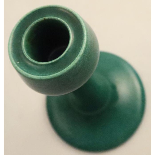 521 - A Ruskin pottery candlestick, decorated in a green glaze, with West Smethwick mark, height 7ins