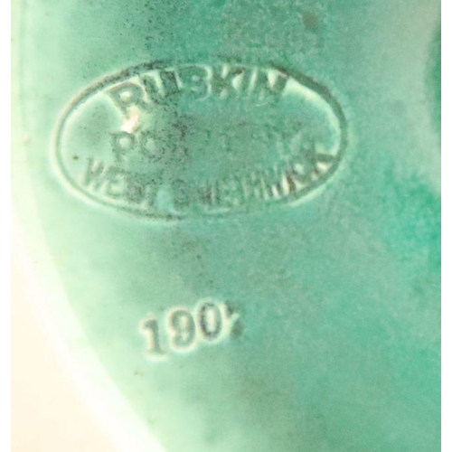 521 - A Ruskin pottery candlestick, decorated in a green glaze, with West Smethwick mark, height 7ins