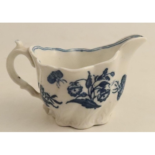 533 - A late 18th/early 19th century moulded cream jug, decorated with blue flowers, height 2.75ins, width... 