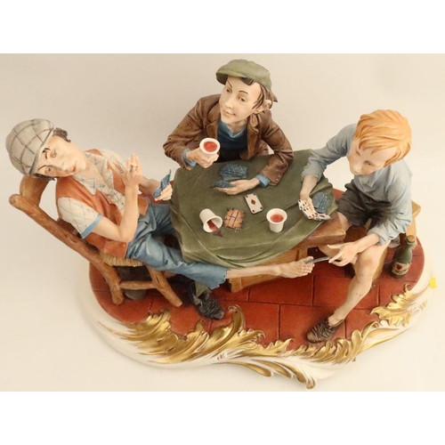 536 - A Capodimonte figure group, of three men playing cards, height 11ins, width 17ins