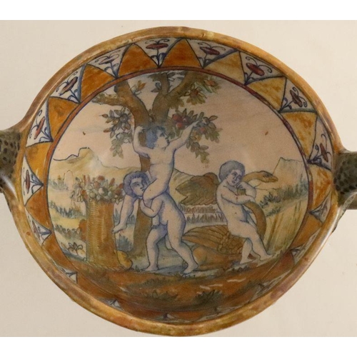 558 - A Cantagalli style pottery two handled pedestal cup, the interior decorated with putti picking apple... 