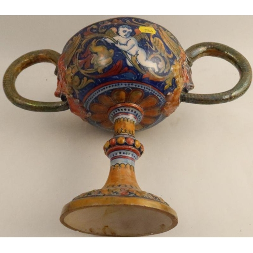 558 - A Cantagalli style pottery two handled pedestal cup, the interior decorated with putti picking apple... 