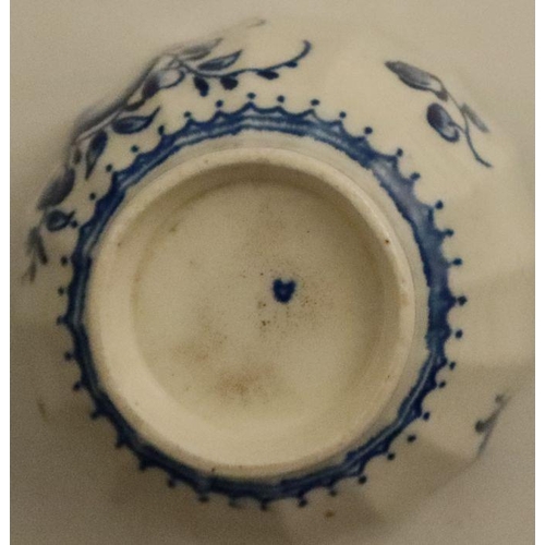 597 - A fluted Worcester tea bowl and saucer, painted in underglaze blue with fruit