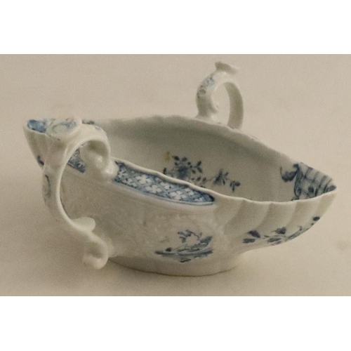 614 - A Worcester two handled moulded sauce boat, painted in underglaze blue with Chinese scenes and lands... 