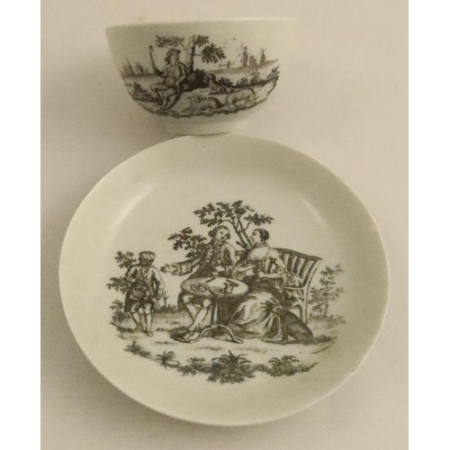 621 - A Worcester tea bowl and saucer, decorated with a black transfer print of the Tea Party