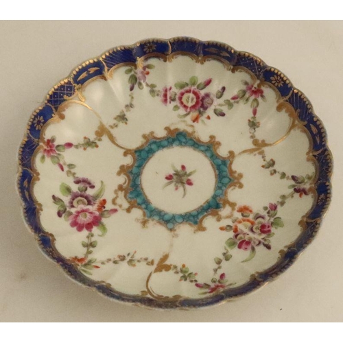 634 - A Worcester tea cup and saucer, the ribbed body decorated with flowers and garlands with a turquoise... 