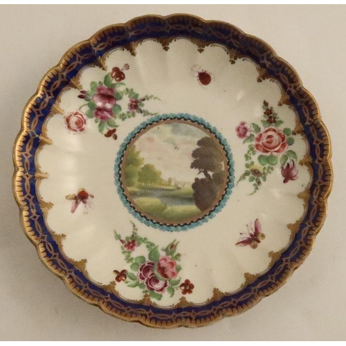 635 - A Worcester fluted tea bowl and saucer decorated with landscape panels, possibly by O'Neil, to blue ... 