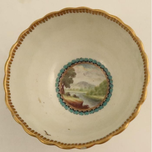 635 - A Worcester fluted tea bowl and saucer decorated with landscape panels, possibly by O'Neil, to blue ... 