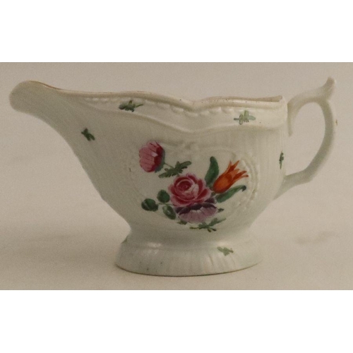 643 - A Worcester moulded sauce boat, decorated with reserves of flowers, length 5ins