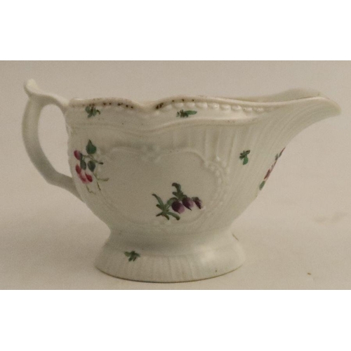 643 - A Worcester moulded sauce boat, decorated with reserves of flowers, length 5ins