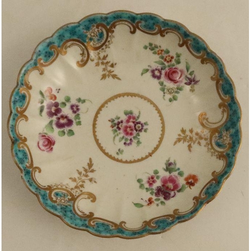 647 - A Worcester fluted tea bowl and saucer, decorated with sprays of flowers to a turquoise border