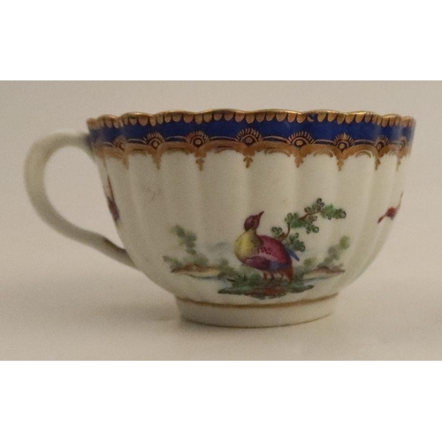 648 - A fluted Worcester teacup, decorated with birds to a blue border, together with a tea bowl with flow... 