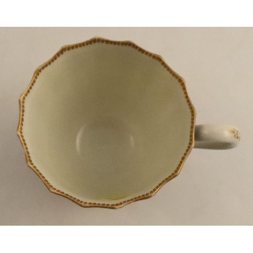 658 - A Worcester cup and saucer, decorated with flowers and blue prunus, seal mark