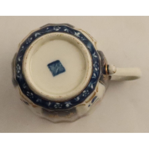 658 - A Worcester cup and saucer, decorated with flowers and blue prunus, seal mark