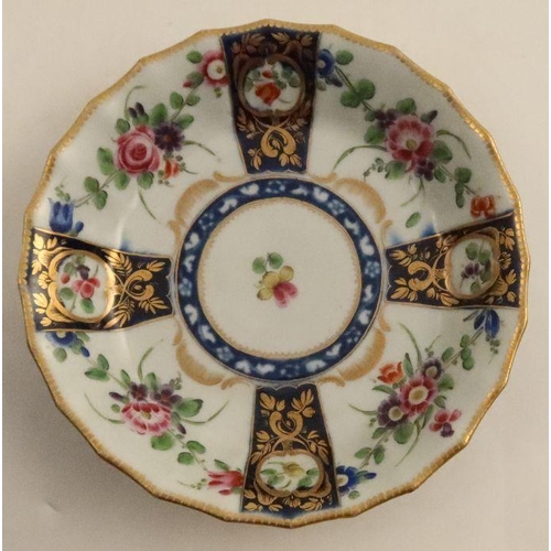 658 - A Worcester cup and saucer, decorated with flowers and blue prunus, seal mark