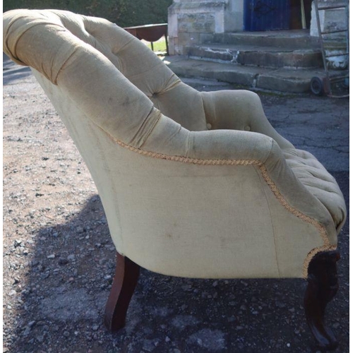 66 - A Victorian upholstered button back armchair, raised on short carved front supports