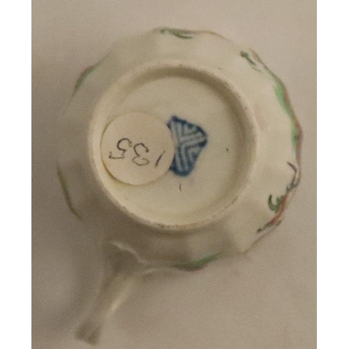 663 - A Worcester tea cup, painted in enamels with wreaths and festoons, together with another coffee cup ... 