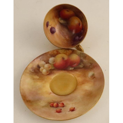 697 - A Royal Worcester cup and saucer, the interior of the cup and the saucer decorated with fruit to a m... 