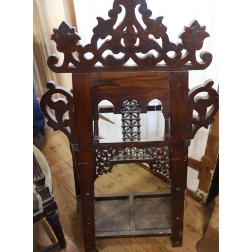 71 - An Eastern style oak stick stand, having carved decoration all over, width 22ins, height 21ins