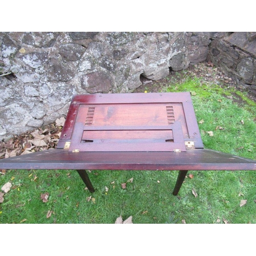 97 - A 19th century mahogany writing table with ratcheted rising top, width 27ins, height 27ins