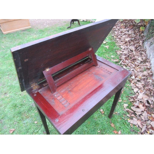 97 - A 19th century mahogany writing table with ratcheted rising top, width 27ins, height 27ins