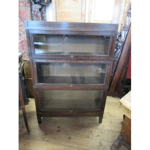 23 - A Globe Wernicke style three section bookcase, with glazed fronts, 34.5ins x 11.5ins, height 49.5ins