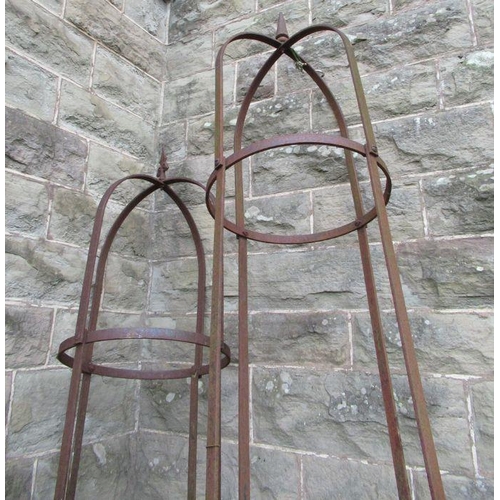 76 - Two metal obelisks