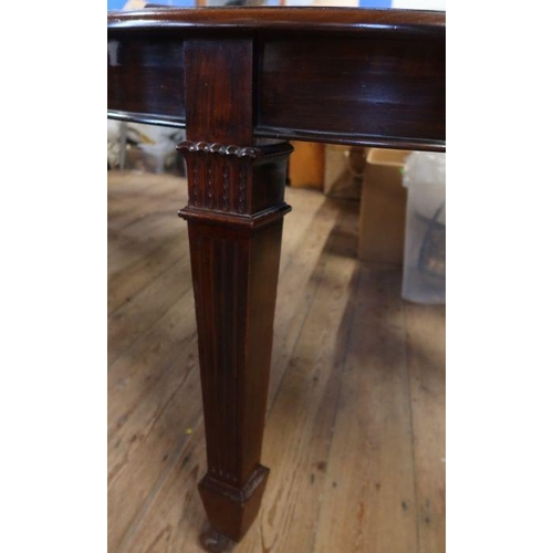 11 - An Edwardian mahogany wind out dining table, raised on carved legs, having three leaves, width 47ins... 