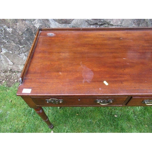 14 - A 19th century mahogany washstand,fitted two frieze drawers, raised on turned legs, 36ins x 19.5ins,... 