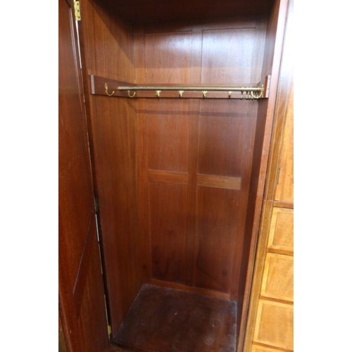 17 - An Edwardian mahogany and inlaid wardrobe, with mirror door, a pair of cupboard doors opening to rev... 