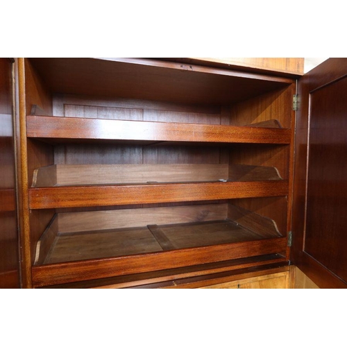 17 - An Edwardian mahogany and inlaid wardrobe, with mirror door, a pair of cupboard doors opening to rev... 