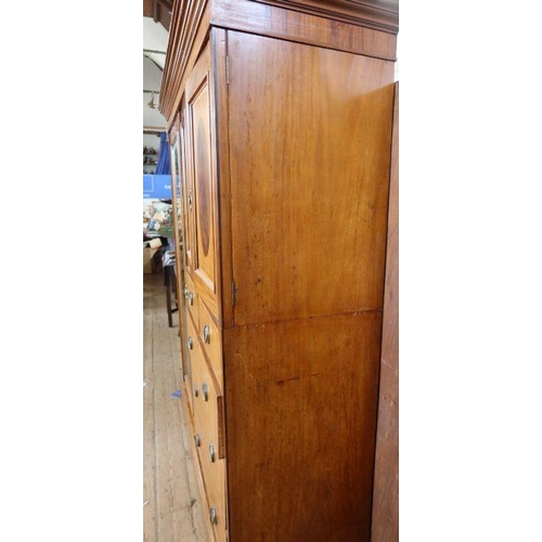 17 - An Edwardian mahogany and inlaid wardrobe, with mirror door, a pair of cupboard doors opening to rev... 