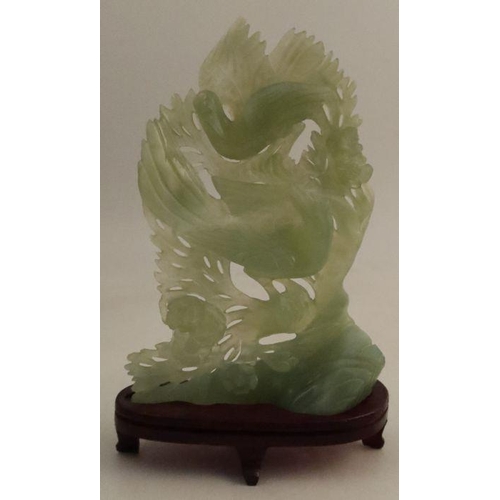 187 - A jade study, of two Phoenix against a foliate background, height including stand 10ins