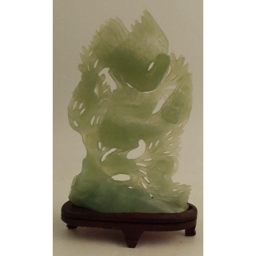 187 - A jade study, of two Phoenix against a foliate background, height including stand 10ins