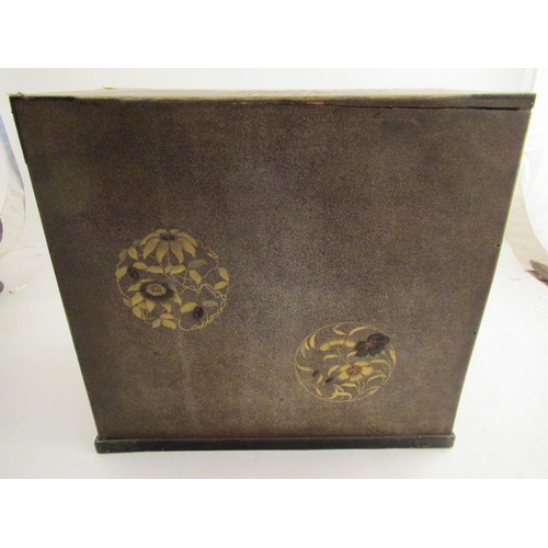 226 - A Japanese table cabinet with gilt chinoiserie decoration, having 2 cupboard doors enclosing draws w... 