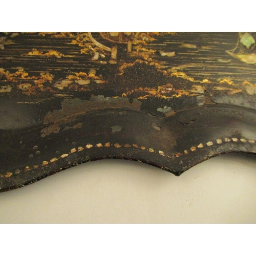 228 - A 19th century toleware tray the ebonized ground decorated in guilt and mother of pearl with a fishi... 