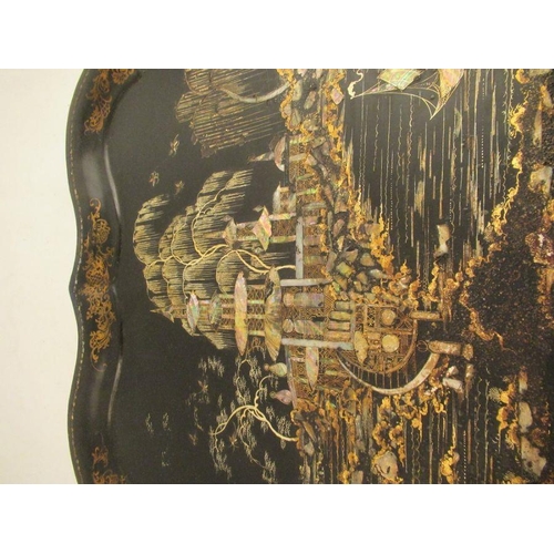 228 - A 19th century toleware tray the ebonized ground decorated in guilt and mother of pearl with a fishi... 