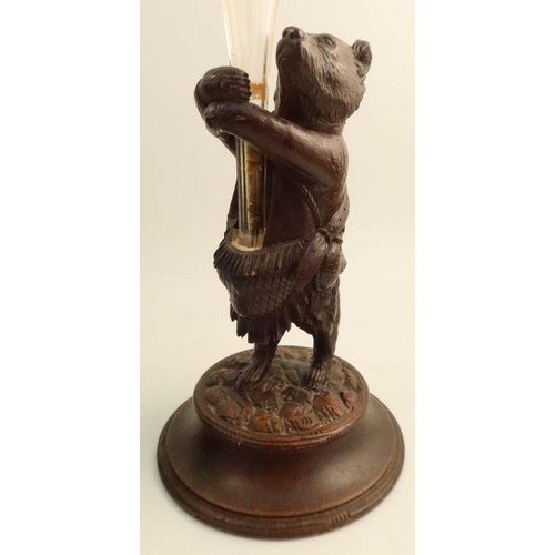 230 - A carved Black Forest wooden model, of a standing bear, holding a glass trumpet shaped vase, togethe... 