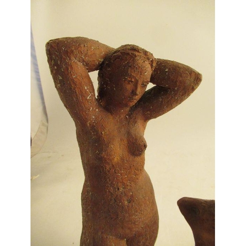 231 - A clay model of a female torso, attributed to Karin Jonzen, with her hands behind her head raised on... 